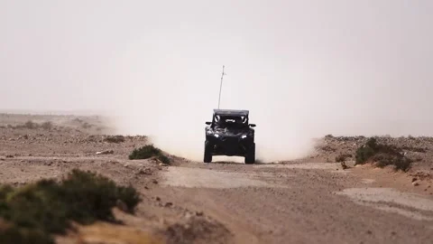 Black Can-Am UTV Approaching on Desert Dirt Track Tunisia Dakar Rally Style Stock Footage 332962987
