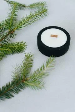 Black Candle Front view. Flat lay Christmas Tree Branches on Side Next to Rou Stock Photos