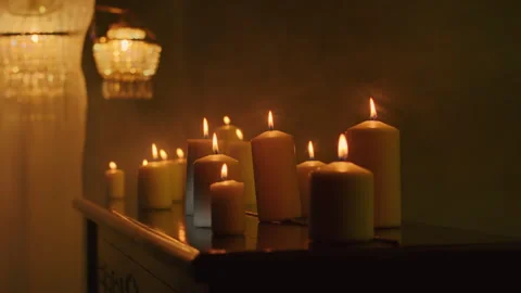 Black candles light up the dark background as a witch performs a magic ritual Stock Footage 240320401