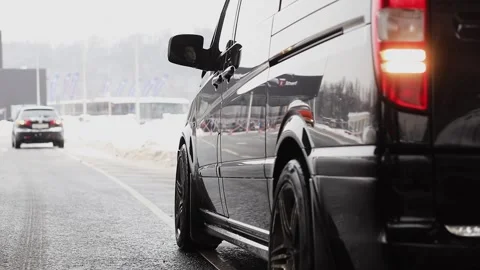 Black car approaches with rear light, at winter Stock Footage 299678653