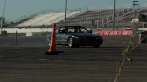 Black Car drifting around corners in parking lot at practice event 스톡 동영상 59746665