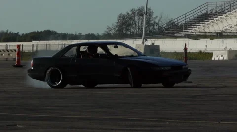 Black Car drifting around corners and spins out of control. Stock Footage 59746669