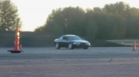 Black car drifts around corner on race track at sunset. Stock Footage 59761983
