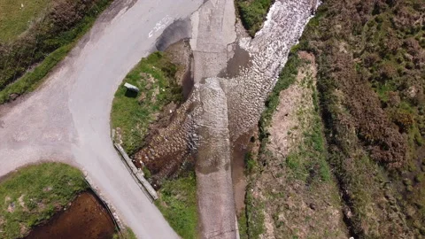 A black car drives through a shallow ford in summer Vídeo Stock 167739090