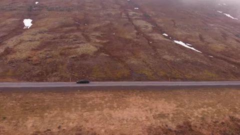 Black car driving on the Ring Road in Iceland in spring. Adventure travel Stock Footage 130853191