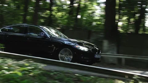 Black car driving through forest Video stock 46123892
