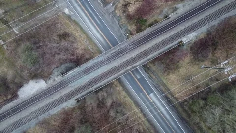 Black Car Driving Under Train Bridge - Black Car on Country Road Video stock 196789988