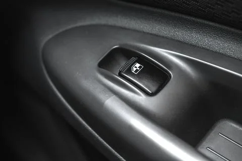 Black car window lifter button in car door close-up background Photos