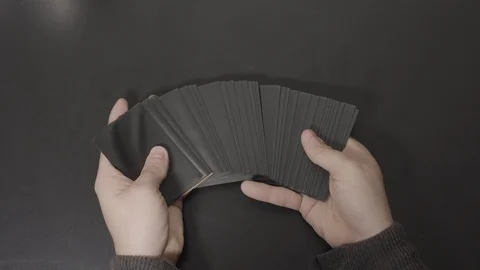 Black Cards Displayed in Hands then Straightened Stock Footage 100550978