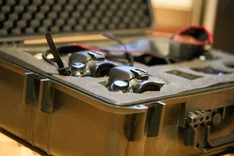 A black case with a pair of goggles and a controller inside Stock Photos