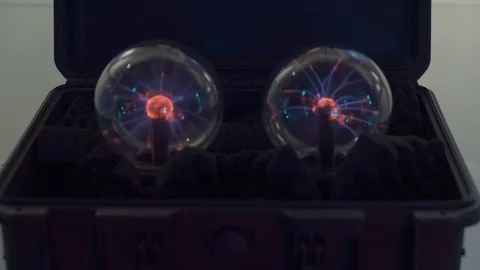 Black case with two electric balls. Lightning flashes inside the glass balls. Th Video stock 98821331
