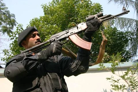 Black Cat commando with an AK 47 light machine gun MR Copyright: xJagannat... Stock Photos