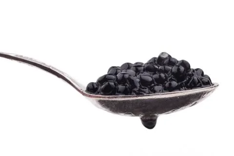 Black caviar beads on spoon Stock Photos