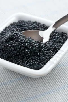 Black caviar in bowl Stock Photos