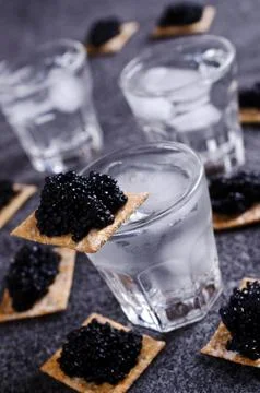 Black caviar on a cracker Stock Photos