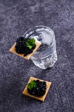 Black caviar on a cracker Stock Photos