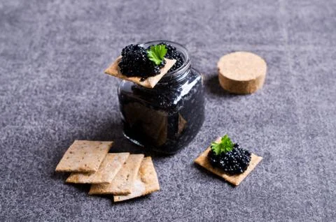 Black caviar on a cracker Stock Photos