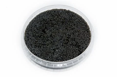 Black caviar in a plastic container Stock Photos