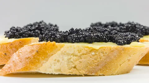 Black caviar on a slice of bread, macro shoot. Stock Footage 63611612