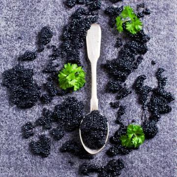 Black caviar in the spoon Foto stock