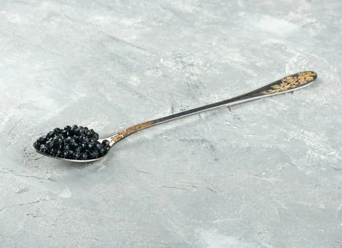 Black caviar in spoon Stock Photos