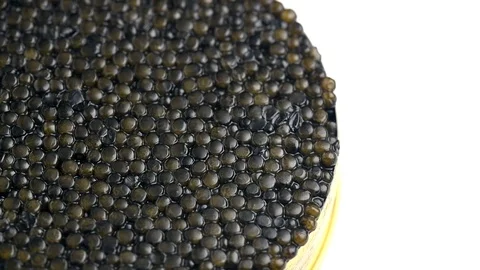 Black caviar. Texture of expensive luxury caviar in tin can rotation on white Vídeos de archivo 107785577