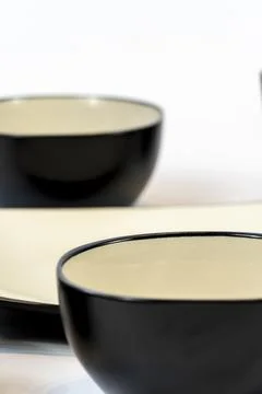 Black ceramic bowl isolated on white background. Stock Photos