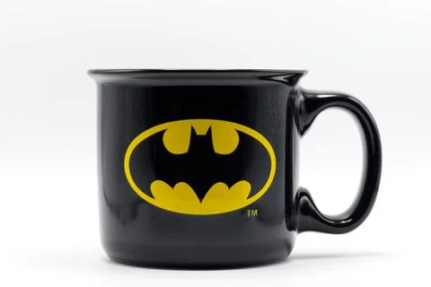 Black ceramic coffee mug with yellow batman superhero logo. Stock Photos