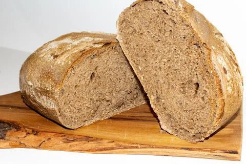 Black cereal bread arranged on a cutting board Stock Photos