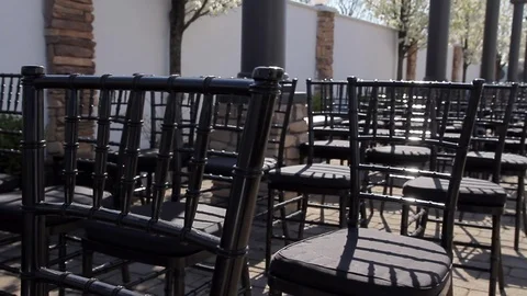 Black chairs set up in rows from ceremony outside Stock Footage 92369206