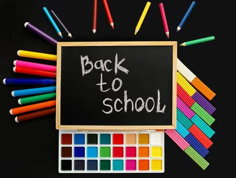 Black chalk board with handwritten Back to school with school felt-tip pens,  Stock Photos