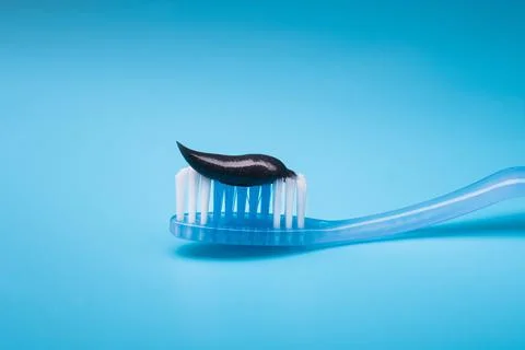 Black charcoal toothpaste on a toothbrush Stock Photos