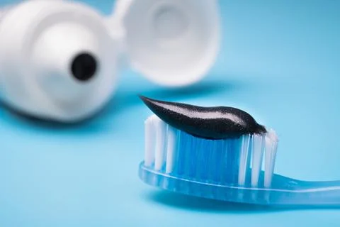 Black charcoal toothpaste on a toothbrush Stock Photos