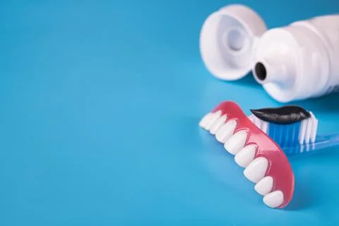 Black charcoal toothpaste on a toothbrush Stock Photos