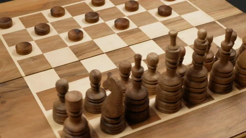 Black chess figures opposite black checkers. spinning around on the board Stock Footage 147441982