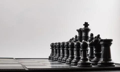 Black chess side view on a black background Stock Photos