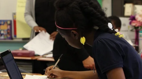 Black child writing in school Stock Footage 92500660
