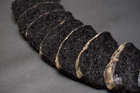 Black ciabatta bread on a black background Stock Photos