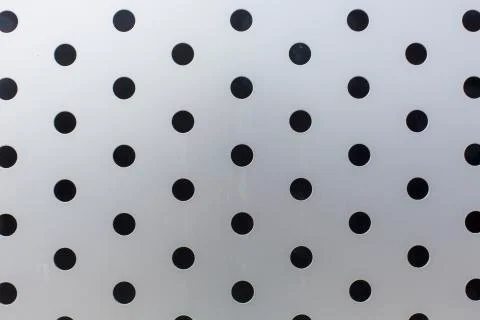 Black circles on a metal surface pattern texture background Stock Photos