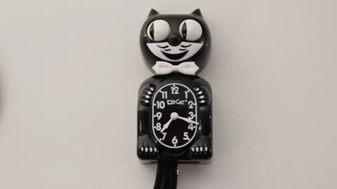 Black Cit Cat Clock On The White Wall Stock Footage 166576734