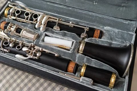 A black clarinet rests in an open case with a plush interior. A perfect shot  Stock Photos