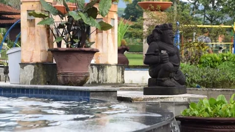 Black classical statue with Indonesian feel at hotel pool Kuningan Stock Footage 312687718
