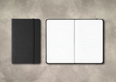 Black closed and open lined notebooks on concrete background Stock Photos