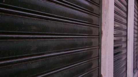 Black closed shutters on windows of store in city street Stock Footage 139354824