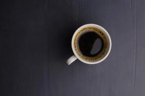 Black closeup on dark backdrop. Coffee espresso on dark background. Stock Photos