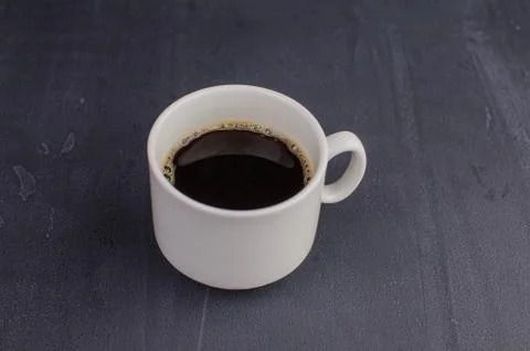 Black closeup on dark backdrop. Coffee espresso on dark background. Stock Photos