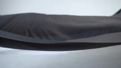 Black Cloth waving on a white background in super slow motion Stock Footage 87764853