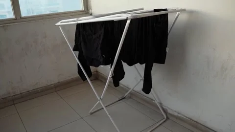 Black Clothes Drying On Metal Rack Indoors Stock Footage 337701530