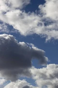 A black cloud behind which the sun hid. Horizontal picture of blue sky wit... Stock Photos