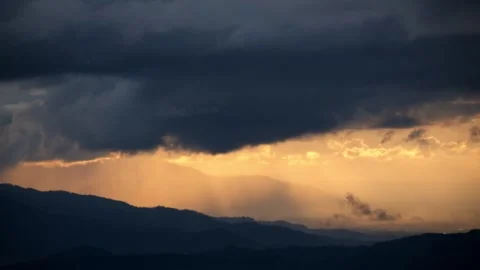 Black clouds and sunlight moved across the hills Stock Footage 293607163